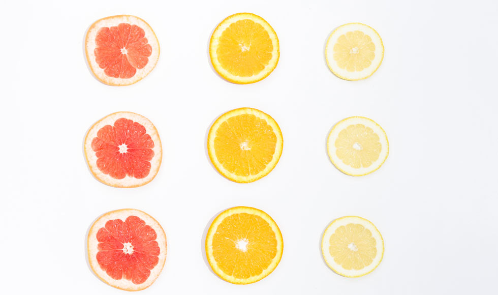 Sliced citrus fruits on a white background
