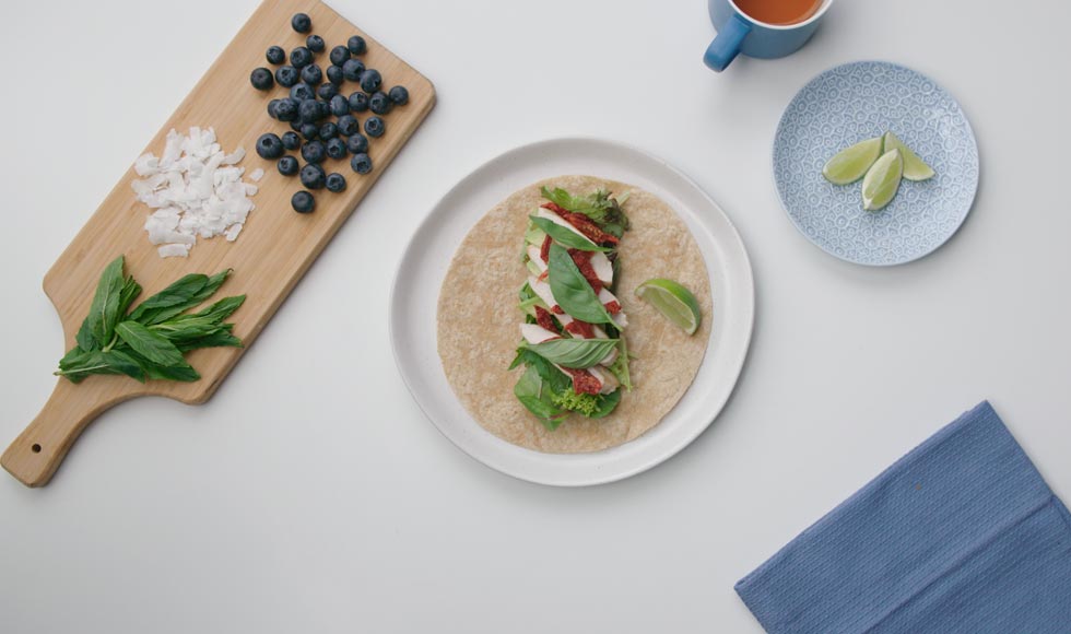 Flat lay of healthy ingredients to make a chicken wrap
