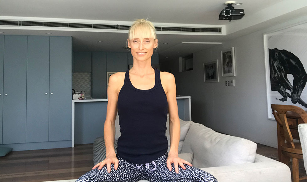 Kate Kendall sitting in a grounding meditation posture