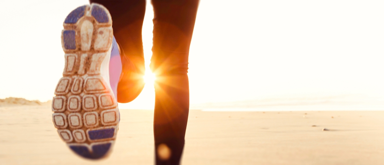 Running feet towards the sunset