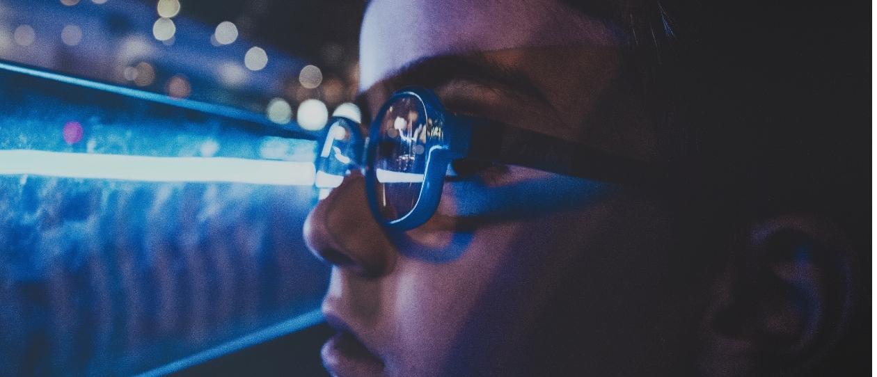 Child looking at blue light wearing blue glasses