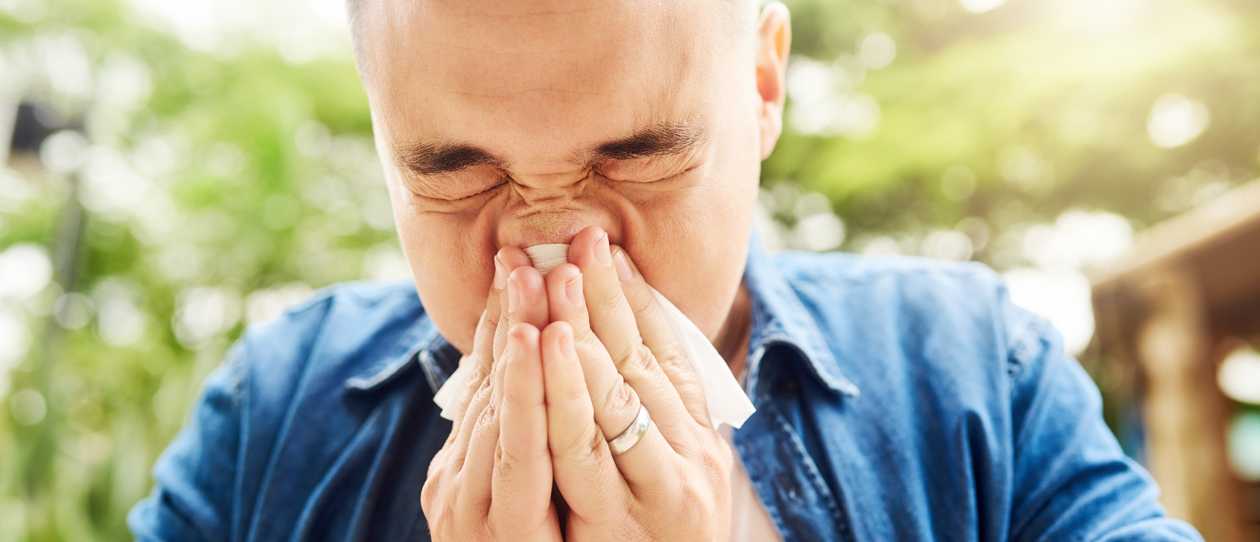 Man with allergies sneezing